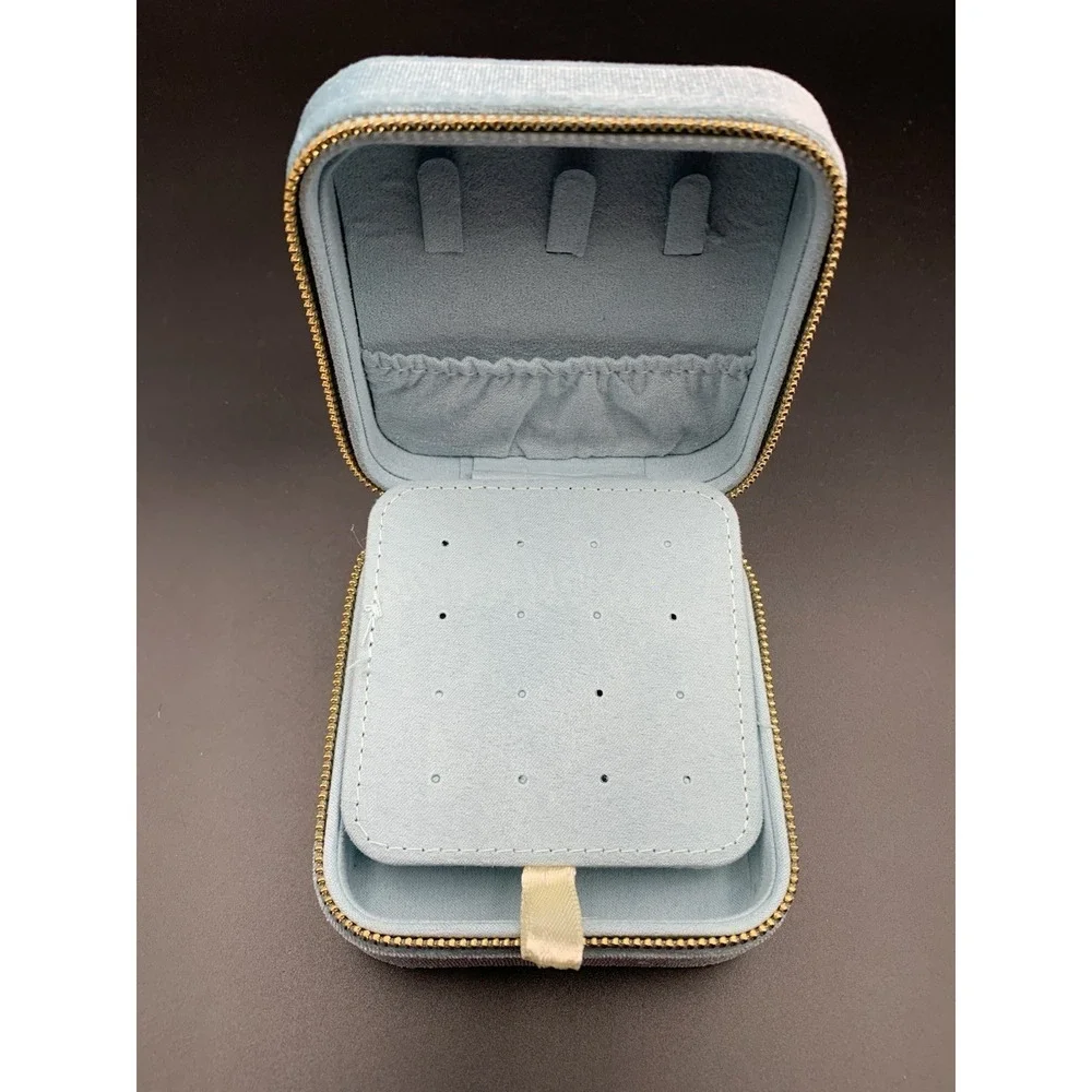 Small blue velvet jewelry box with a zipper